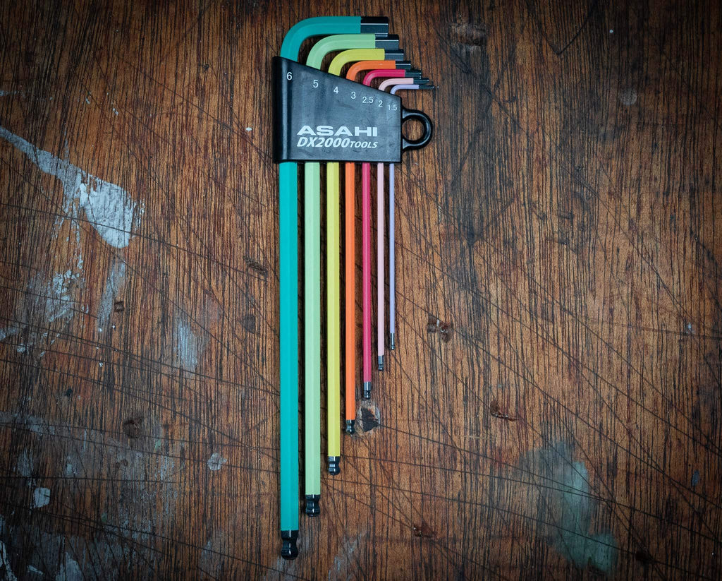 Asahi colored Allen hex key long set of 7 on a wooden surface.